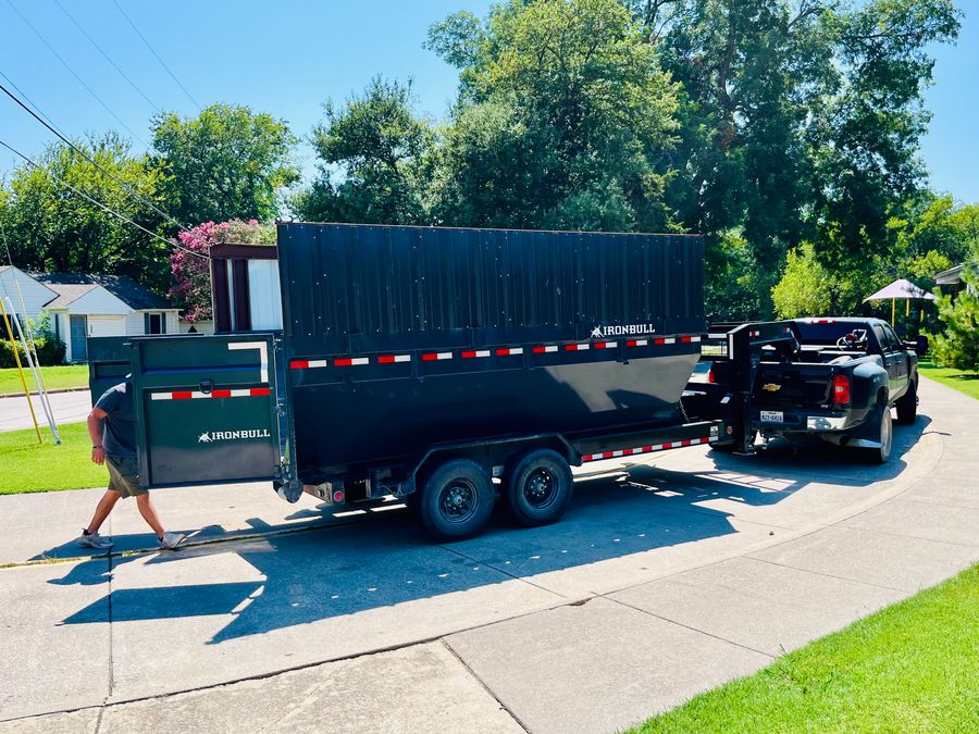 Country Cousins crew loading a full IronBull trailer for a junk removal job